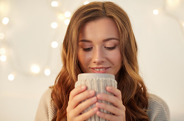 Image showing happy woman with cup of tea or coffee at home