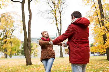 Image showing happy young couple having fun in autumn park