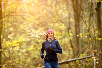 Image showing Smiling sportswoman runs in morning