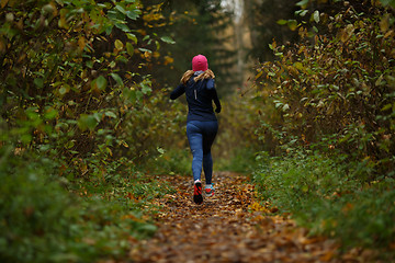 Image showing Blonde woman running on trail