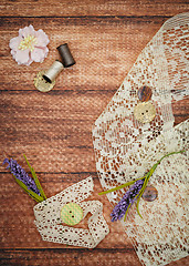 Image showing Lace and thread on wooden background