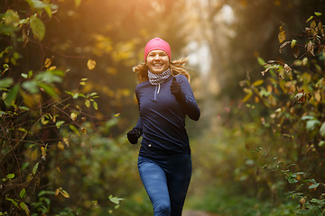 Image showing Happy woman athlete Jogging in autumn forest. Healthy lifestyle concept