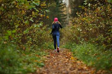 Image showing Blonde sportswoman runs on track