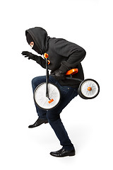 Image showing Burglar sneaking small child bike