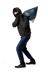 Image showing Thief carries heavy big bag