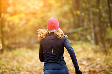 Image showing Blonde sportswoman runs in morning