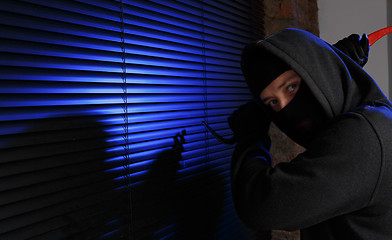 Image showing Robber trying open window night