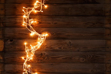 Image showing Glowing garland on wooden floor