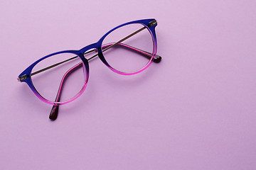 Image showing Multi-colored glasses in purple background