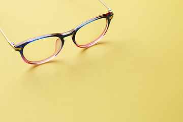 Image showing Blue-pink glasses on yellow space