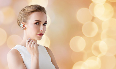 Image showing woman in white with jewelry over holidays lights