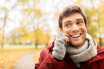 Image showing man with smartphone calling on city street