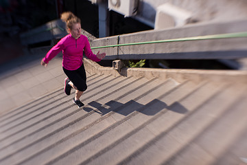 Image showing woman jogging on  steps