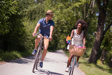 Image showing Young multiethnic couple having a bike ride in nature