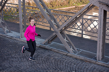 Image showing sporty woman jogging on morning