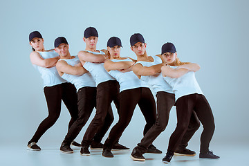 Image showing Group of men and women dancing hip hop choreography