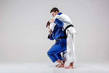 Image showing The two judokas fighters fighting men