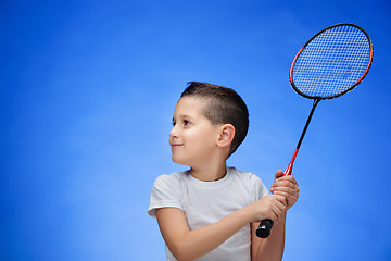 Image showing The boy with badminton rackets outdoors