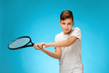 Image showing Young tennis player on blue background.