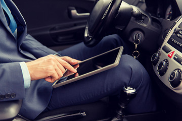 Image showing close up of young man with tablet pc driving car