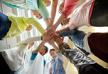 Image showing group of international students with hands on top