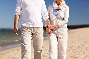 Image showing close up of senior couple walking on summer beach