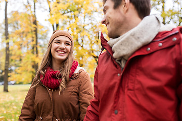 Image showing happy young couple walking in autumn park