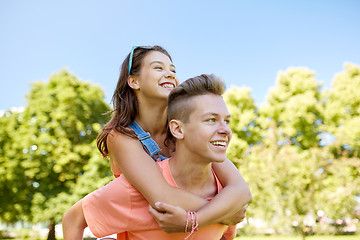 Image showing happy teenage couple having fun at summer park