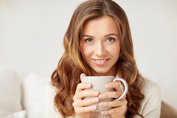 Image showing close up of happy woman with coffee cup at home