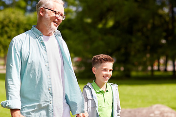 Image showing grandfather and grandson walking at summer park