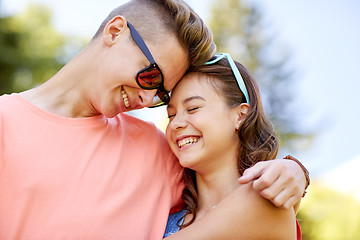 Image showing happy teenage couple hugging at summer