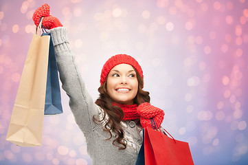 Image showing woman with shopping bags over christmas lights 