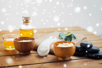 Image showing body scrub, towel with brush and massage oil