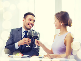 Image showing couple with main course and red wine at restaurant