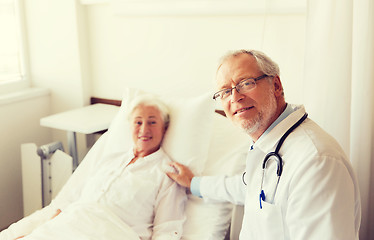 Image showing doctor visiting senior woman at hospital ward