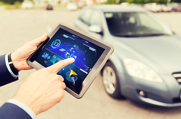 Image showing male hands with navigator on tablet pc and car