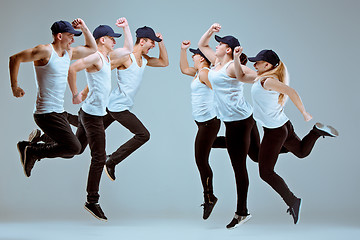 Image showing Group of men and women dancing hip hop choreography