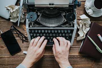 Image showing Writer typing with retro writing machine.