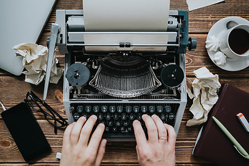 Image showing Writer typing with retro writing machine.