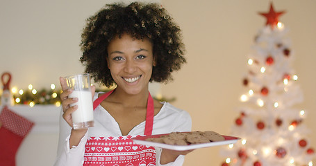 Image showing Happy young woman with milk and cookies for Santa