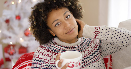 Image showing Smiling friendly young woman relaxing at Christmas