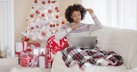 Image showing Young woman relaxing in front of a Christmas tree