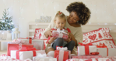 Image showing Daughter and mother in bed with Christmas gifts