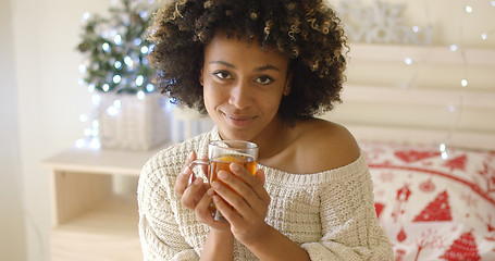 Image showing Smiling woman holding hot tea