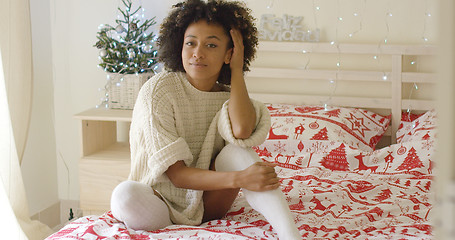 Image showing Beautiful young woman sitting in bed