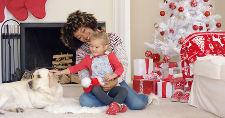 Image showing Happy mother and child with dog on Christmas Day