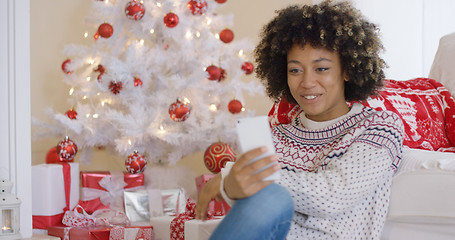 Image showing Pretty young woman video chatting on her smartphone