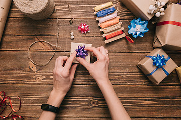 Image showing Crop hands decorating present