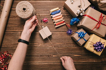 Image showing Crop hands decorating present