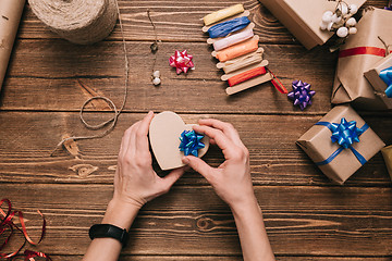 Image showing Crop hands decorating present